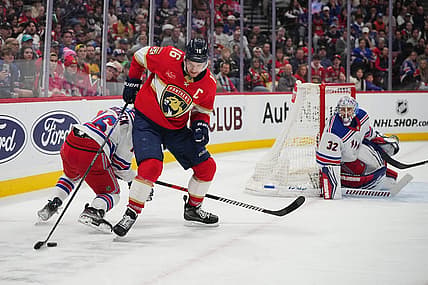 Dec 29, 2023; Sunrise, Florida, USA; Florida Panthers center Aleksander Barkov (16) controls the puck against the New York Rangers during the second period at Amerant Bank Arena. Mandatory Credit: Jasen Vinlove-USA TODAY Sports