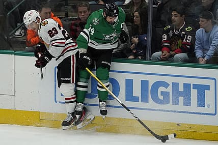 Dec 29, 2023; Dallas, Texas, USA; Chicago Blackhawks center Philipp Kurashev (23) takes Dallas Stars left wing Jamie Benn (14) off the puck during the first period at American Airlines Center. Mandatory Credit: Raymond Carlin III-USA TODAY Sports