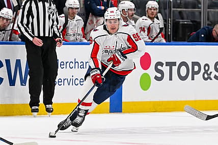 Dec 29, 2023; Elmont, New York, USA; Washington Capitals right wing Nicolas Aube-Kubel (96) skates with the puck against the New York Islanders during the third period at UBS Arena. Mandatory Credit: Dennis Schneidler-USA TODAY Sports