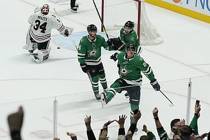 Dec 29, 2023; Dallas, Texas, USA; Dallas Stars center Roope Hintz (24) reacts with defenseman Miro Heiskanen (4) and left wing Jason Robertson (21) in front of Chicago Blackhawks goaltender Petr Mrazek (34) after scoring the game winning goal during overtime at American Airlines Center. Mandatory Credit: Raymond Carlin III-USA TODAY Sports