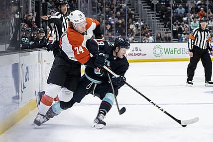 Dec 29, 2023; Seattle, Washington, USA; Seattle Kraken forward Jared McCann (19) and Philadelphia Flyers forward Owen Tippett (74) battle for the puck during the first period at Climate Pledge Arena. Mandatory Credit: Stephen Brashear-USA TODAY Sports