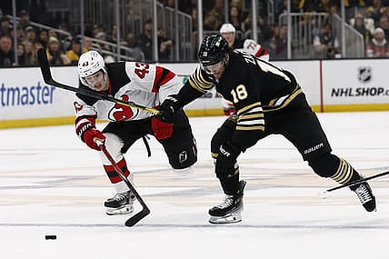 Dec 30, 2023; Boston, Massachusetts, USA; Boston Bruins center Pavel Zacha (18) races New Jersey Devils defenseman Luke Hughes (43) for a loose puck during the first period at TD Garden. Mandatory Credit: Winslow Townson-USA TODAY Sports