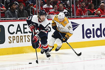 Dec 30, 2023; Washington, District of Columbia, USA; Washington Capitals defenseman Rasmus Sandin (38) advances the puck as Nashville Predators center Gustav Nyquist (14) chases during the second period at Capital One Arena. Mandatory Credit: Brad Mills-USA TODAY Sports