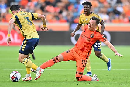 Oct 29, 2023; Houston, TX, USA; Houston Dynamo forward Corey Baird (11) kicks the bal from Real Salt Lake defender Bryan Oviedo (3) in the first half for game one in a round one match of the 2023 MLS Cup Playoffs at Shell Energy Stadium. Mandatory Credit: Maria Lysaker-USA TODAY Sports