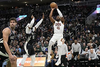 Jan 26, 2024; Milwaukee, Wisconsin, USA;  Cleveland Cavaliers guard Donovan Mitchell (45) shoots against Milwaukee Bucks forward Jae Crowder (99) during the third quarter at Fiserv Forum. Mandatory Credit: Jeff Hanisch-USA TODAY Sports