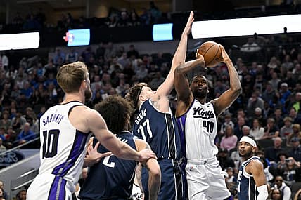 Jan 27, 2024; Dallas, Texas, USA; Sacramento Kings forward Harrison Barnes (40) looks to shoot over Dallas Mavericks guard Luka Doncic (77) during the first quarter at the American Airlines Center. Mandatory Credit: Jerome Miron-USA TODAY Sports