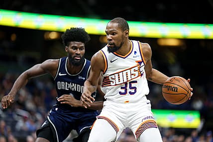 Jan 28, 2024; Orlando, Florida, USA;  Phoenix Suns forward Kevin Durant (35) drives to the hoop past Orlando Magic forward Jonathan Isaac (1) in the second quarter at the Kia Center. Mandatory Credit: Nathan Ray Seebeck-USA TODAY Sports