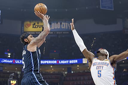 Jan 13, 2024; Oklahoma City, Oklahoma, USA; Orlando Magic forward Paolo Banchero (5) shoots as Oklahoma City Thunder guard Luguentz Dort (5) defends during the first quarter at Paycom Center. Mandatory Credit: Alonzo Adams-USA TODAY Sports