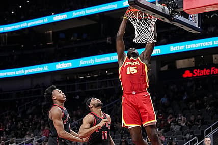 Jan 28, 2024; Atlanta, Georgia, USA; Atlanta Hawks center Clint Capela (15) dunks behind Toronto Raptors forwards Scottie Barnes (4) and Bruce Brown (11) during the first half at State Farm Arena. Mandatory Credit: Dale Zanine-USA TODAY Sports