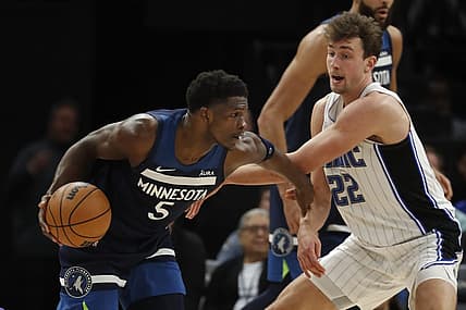Feb 2, 2024; Minneapolis, Minnesota, USA; Minnesota Timberwolves guard Anthony Edwards (5) works around Orlando Magic forward Franz Wagner (22) in the fourth quarter at Target Center. Mandatory Credit: Bruce Kluckhohn-USA TODAY Sports