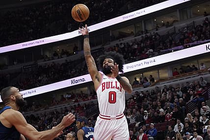 Feb 6, 2024; Chicago, Illinois, USA; Chicago Bulls guard Coby White (0) shoots over Minnesota Timberwolves center Rudy Gobert (27) during the first quarter at United Center. Mandatory Credit: David Banks-USA TODAY Sports