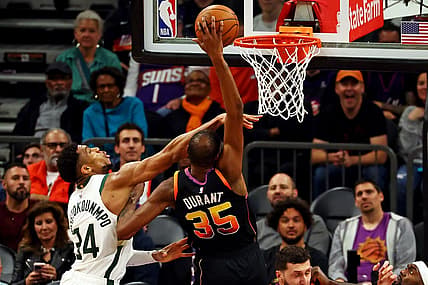 Feb 6, 2024; Phoenix, Arizona, USA; Phoenix Suns forward Kevin Durant (35) shoots the ball against Milwaukee Bucks forward Giannis Antetokounmpo (34) during the fourth quarter at Footprint Center. Mandatory Credit: Mark J. Rebilas-USA TODAY Sports