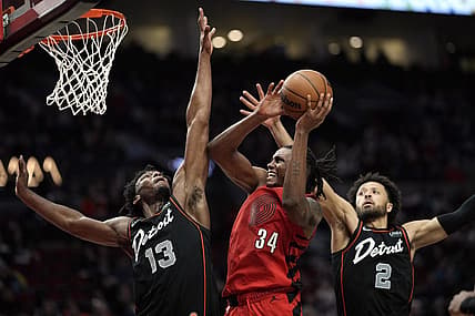Feb 8, 2024; Portland, Oregon, USA; Portland Trail Blazers forward Jabari Walker (34) shoots the ball against Detroit Pistons center James Wiseman (13) and point guard Cade Cunningham (2) during the second half at Moda Center. Mandatory Credit: Soobum Im-USA TODAY Sports