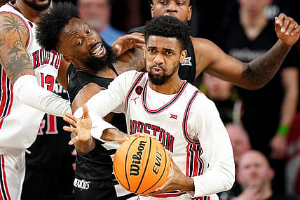 Cincinnati Bearcats forward John Newman III (15) reaches for a rebound against Houston Cougars guard Mylik Wilson (8) in the second half of an NCAA college basketball game between the Houston Cougars and the Cincinnati Bearcats, Saturday, Feb. 10, 2024, at Fifth Third Arena in Cincinnati.