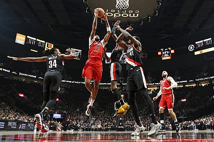 Feb 10, 2024; Portland, Oregon, USA; New Orleans Pelicans small forward Brandon Ingram (14) drives for the basket between Portland Trail Blazers forward Jabari Walker (34) and small forward Jerami Grant (9, right) during the first half at Moda Center. Mandatory Credit: Soobum Im-USA TODAY Sports