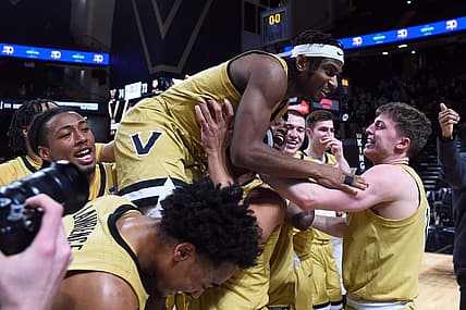 Feb 13, 2024; Nashville, Tennessee, USA; Vanderbilt Commodores guard Ezra Manjon (5) celebrates with teammates after making the game-winning basket against the Texas A&M Aggies at Memorial Gymnasium. Mandatory Credit: Christopher Hanewinckel-USA TODAY Sports
