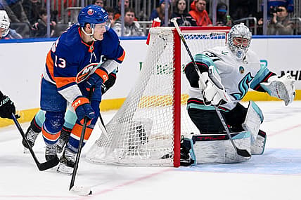 Feb 13, 2024; Elmont, New York, USA; New York Islanders center Mathew Barzal (13) attempts. A pass behind Seattle Kraken goaltender Philipp Grubauer (31) during the second period at UBS Arena. Mandatory Credit: Dennis Schneidler-USA TODAY Sports