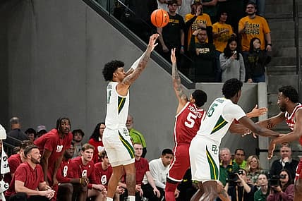 Feb 13, 2024; Waco, Texas, USA;  Baylor Bears forward Jalen Bridges (11) scores a three point basket against Oklahoma Sooners guard Rivaldo Soares (5) during the first half at Paul and Alejandra Foster Pavilion. Mandatory Credit: Chris Jones-USA TODAY Sports