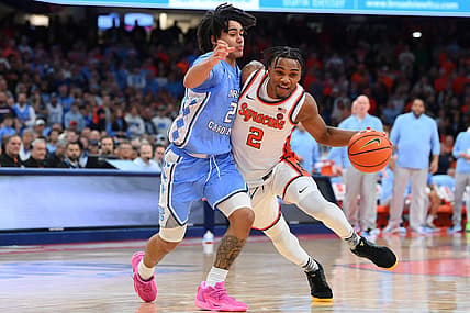 Feb 13, 2024; Syracuse, New York, USA; Syracuse Orange guard JJ Starling (2) drives to the basket as North Carolina Tar Heels guard Elliot Cadeau (2) defends during the second half at the JMA Wireless Dome. Mandatory Credit: Rich Barnes-USA TODAY Sports