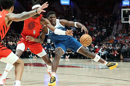 Feb 13, 2024; Portland, Oregon, USA; Minnesota Timberwolves guard Anthony Edwards (5) fights for possession against Portland Trail Blazers forward Jerami Grant (9) in the first quarter at Moda Center. Mandatory Credit: Jaime Valdez-USA TODAY Sports