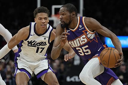 Feb 13, 2024; Phoenix, Arizona, USA; Phoenix Suns forward Kevin Durant (35) drives on Sacramento Kings forward Kessler Edwards (17)  in the first half at Footprint Center. Mandatory Credit: Rick Scuteri-USA TODAY Sports