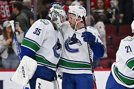 Feb 13, 2024; Chicago, Illinois, USA; Vancouver Canucks goaltender Thatcher Demko (35) and forward Elias Lindholm (23) celebrate after defeating the Chicago Blackhawks 4-2 at United Center. Mandatory Credit: Jamie Sabau-USA TODAY Sports