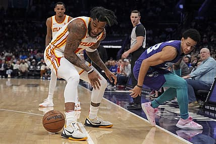 Feb 14, 2024; Charlotte, North Carolina, USA; Atlanta Hawks forward Saddiq Bey (41) loses the ball defended by Charlotte Hornets guard Tre Mann (23) during the second quarter at Spectrum Center. Mandatory Credit: Jim Dedmon-USA TODAY Sports