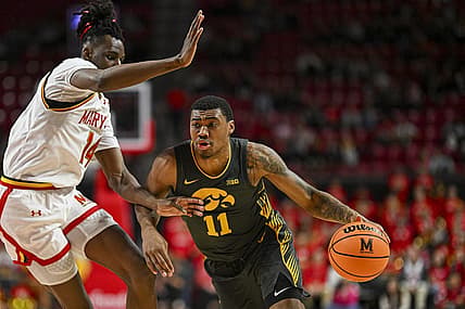 Feb 14, 2024; College Park, Maryland, USA;  Iowa Hawkeyes guard Tony Perkins (11) drive to the basket on Maryland Terrapins forward Mady Traore (14) during the fist half at Xfinity Center. Mandatory Credit: Tommy Gilligan-USA TODAY Sports