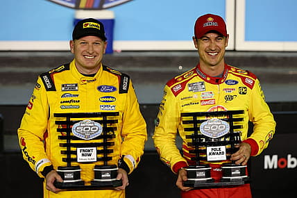 Feb 14, 2024; Daytona Beach, Florida, USA; NASCAR Cup Series driver Joey Logano (right) poses with the pole award with driver Michael McDowell (left), qualified second, after qualifying for the Daytona 500 at Daytona International Speedway. Mandatory Credit: Mark J. Rebilas-USA TODAY Sports