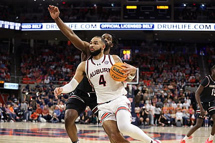 Feb 14, 2024; Auburn, Alabama, USA; Auburn Tigers forward Johni Broome (4) gets past South Carolina Gamecocks forward Josh Gray (33) for a shot during the second half at Neville Arena. Mandatory Credit: John Reed-USA TODAY Sports
