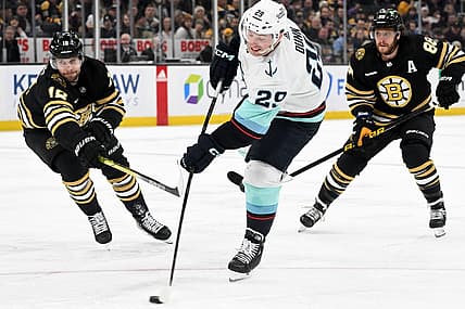 Feb 15, 2024; Boston, Massachusetts, USA; Seattle Kraken defenseman Vince Dunn (29) takes a shot in front of Boston Bruins center Pavel Zacha (18) during the second period at the TD Garden. Mandatory Credit: Brian Fluharty-USA TODAY Sports