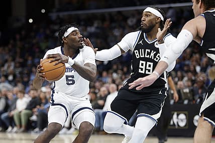 Feb 15, 2024; Memphis, Tennessee, USA; Memphis Grizzlies guard Vince Williams Jr. (5) handles the ball as Milwaukee Bucks forward Jae Crowder (99) defends during the first half at FedExForum. Mandatory Credit: Petre Thomas-USA TODAY Sports