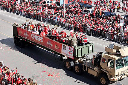 Feb 14, 2024; Kansas City, MO, USA; Fan watch the parade procession during the celebration of the Kansas City Chiefs winning Super Bowl LVIII. Mandatory Credit: Julia Kapros-USA TODAY Sports