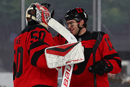 Feb 17, 2024; East Rutherford, New Jersey, USA; New Jersey Devils goaltender Nico Daws (50) and center Nico Hischier (13) celebrate their win over the Philadelphia Flyers in a Stadium Series ice hockey game at MetLife Stadium. Mandatory Credit: Ed Mulholland-USA TODAY Sports