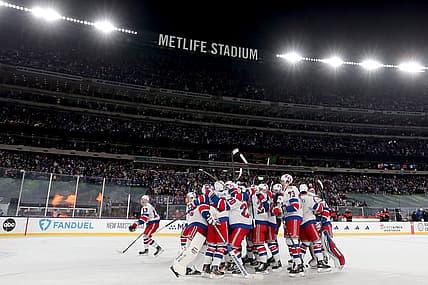 Feb 18, 2024; East Rutherford, New Jersey, USA; New York Rangers players celebrate after defeating the New York Islanders during the overtime period of a Stadium Series ice hockey game at MetLife Stadium. Mandatory Credit: Brad Penner-USA TODAY Sports