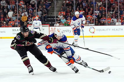 Feb 19, 2024; Tempe, Arizona, USA; Arizona Coyotes defenseman Josh Brown (3) checks Edmonton Oilers center Ryan McLeod (71) during the second period at Mullett Arena. Mandatory Credit: Joe Camporeale-USA TODAY Sports