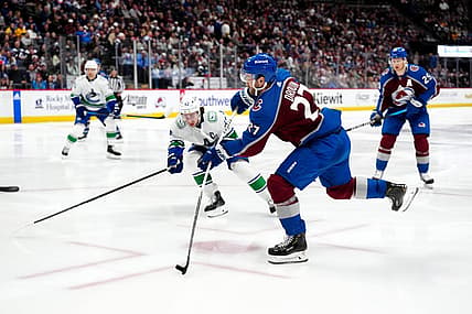 Feb 20, 2024; Denver, Colorado, USA; Colorado Avalanche left wing Jonathan Drouin (27) shoots the puck in the second period against the Vancouver Canucks at Ball Arena. Mandatory Credit: Ron Chenoy-USA TODAY Sports