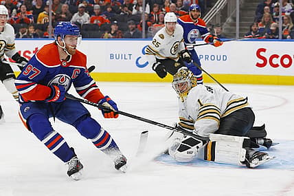 Feb 21, 2024; Edmonton, Alberta, CAN; Boston Bruins goaltender Jeremy Swayman (1) makes a save on  on Edmonton Oilers forward Connor McDavid (97) during the third period at Rogers Place. Mandatory Credit: Perry Nelson-USA TODAY Sports
