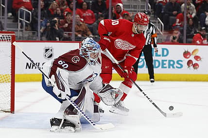 Feb 22, 2024; Detroit, Michigan, USA;  Detroit Red Wings center Joe Veleno (90) tries to score on Colorado Avalanche goaltender Justus Annunen (60) in the second period at Little Caesars Arena. Mandatory Credit: Rick Osentoski-USA TODAY Sports