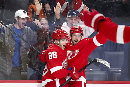 Feb 22, 2024; Detroit, Michigan, USA;  Detroit Red Wings right wing Patrick Kane (88) receives congratulations from center Dylan Larkin (71) after scoring in overtime against the Colorado Avalanche at Little Caesars Arena. Mandatory Credit: Rick Osentoski-USA TODAY Sports