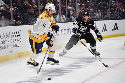 Feb 22, 2024; Los Angeles, California, USA; Nashville Predators left wing Filip Forsberg (9) controls the puck against Los Angeles Kings defenseman Vladislav Gavrikov (84) during the first period at Crypto.com Arena. Mandatory Credit: Gary A. Vasquez-USA TODAY Sports