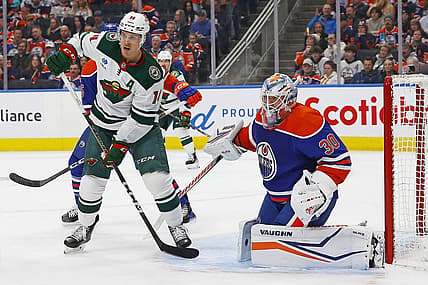 Feb 23, 2024; Edmonton, Alberta, CAN; Minnesota Wild forward Joel Ericksson EK (14) looks for a deletion in front of Edmonton Oilers goaltender Calvin Pickard (30) during the second period at Rogers Place. Mandatory Credit: Perry Nelson-USA TODAY Sports