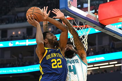 Feb 23, 2024; San Francisco, California, USA; Golden State Warriors forward Andrew Wiggins (22) shoots against Charlotte Hornets center Nick Richards (4) during the second quarter at Chase Center. Mandatory Credit: Darren Yamashita-USA TODAY Sports