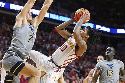 Iowa State Cyclones guard Keshon Gilbert (10) shoots the ball as West Virginia Mountaineers guard Jesse Edwards (7) defends during the first half in the Big-12 conference showdown of a NCAA college basketball at Hilton Coliseum on Feb. x, 2024, in Ames, Iowa.
