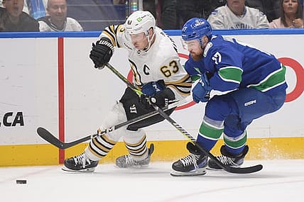 Feb 24, 2024; Vancouver, British Columbia, CAN;  Vancouver Canucks defenseman Filip Hronek (17) checks Boston Bruins forward Brad Marchand (63) during the second period at Rogers Arena. Mandatory Credit: Anne-Marie Sorvin-USA TODAY Sports