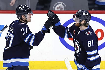 Feb 25, 2024; Winnipeg, Manitoba, CAN; Winnipeg Jets left wing Kyle Connor (81) celebrates his overtime goal with Winnipeg Jets left wing Nikolaj Ehlers (27) against the Arizona Coyotes at Canada Life Centre. Mandatory Credit: James Carey Lauder-USA TODAY Sports