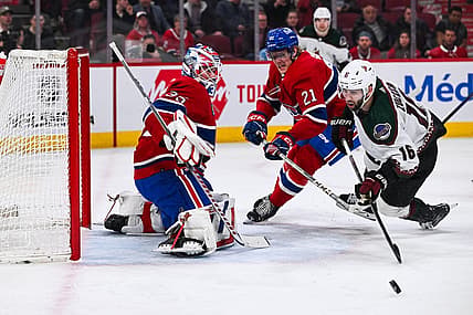 Feb 27, 2024; Montreal, Quebec, CAN; Montreal Canadiens goalie Sam Montembeault (35) makes a save against Arizona Coyotes left wing Jason Zucker (16) during the first period at Bell Centre. Mandatory Credit: David Kirouac-USA TODAY Sports