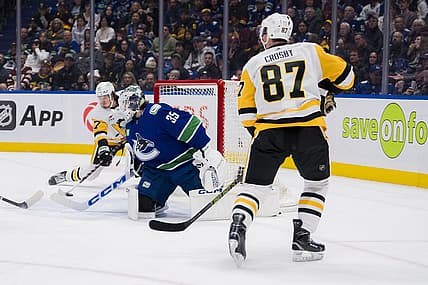 Feb 27, 2024; Vancouver, British Columbia, CAN; Pittsburgh Penguins forward Sidney Crosby (87) watches as forward Rickard Rakell (67) scores on Vancouver Canucks goalie Thatcher Demko (35) in the second period at Rogers Arena. Mandatory Credit: Bob Frid-USA TODAY Sports
