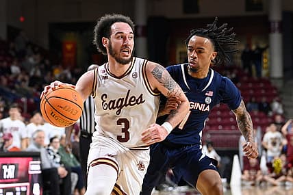 Feb 28, 2024; Chestnut Hill, Massachusetts, USA; Boston College Eagles guard Jaeden Zackery (3) drives the ball  against Virginia Cavaliers guard Dante Harris (1) during the second half at Conte Forum. Mandatory Credit: Eric Canha-USA TODAY Sports