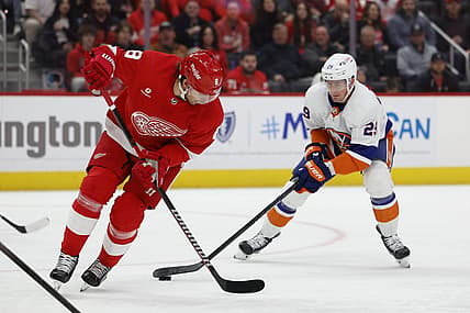 Feb 29, 2024; Detroit, Michigan, USA;  New York Islanders center Brock Nelson (29) skates with the puck defended by Detroit Red Wings defenseman Ben Chiarot (8) in the first period at Little Caesars Arena. Mandatory Credit: Rick Osentoski-USA TODAY Sports